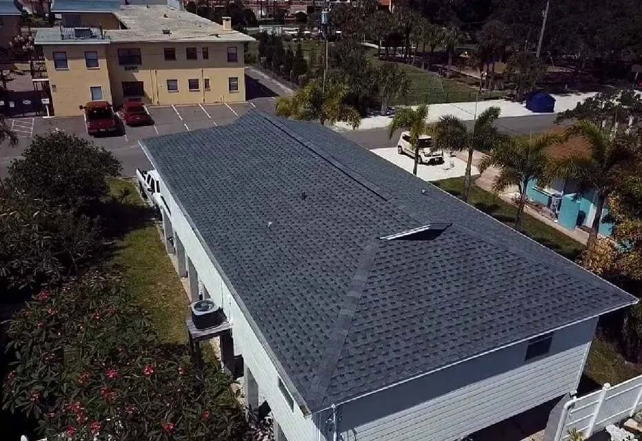 Dark shingle roof on a long multi-unit building