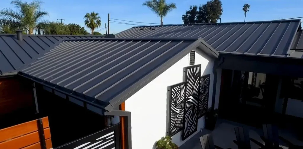 Black standing seam metal roof on a modern home